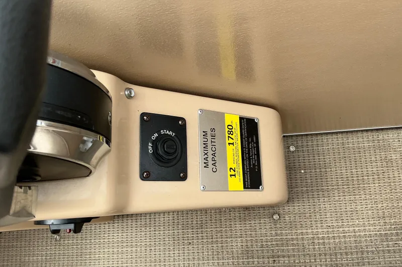 Slide: The Image of 2019 Avalon Catalina Quad Lounge boat dashboard with capacity label and ignition switch. - 9