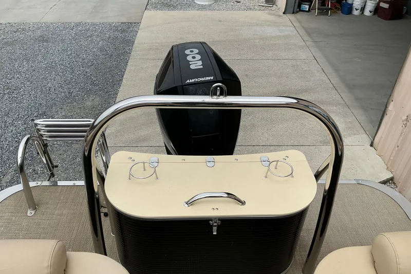 Slide: The Image of 2019 Avalon Catalina Quad Lounge boat with Mercury outboard motor, docked on concrete. - 6