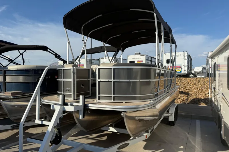 Slide: The Image of 2023 South Bay 224RS LE pontoon boat with canopy, parked on a trailer. - 15