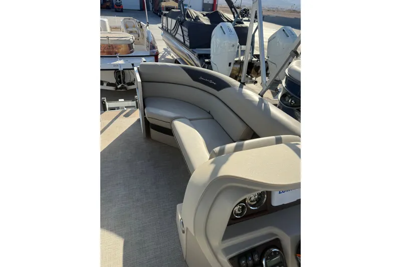 Slide: The Image of 2023 South Bay 224RS LE pontoon boat interior with plush seating and modern dashboard. - 9