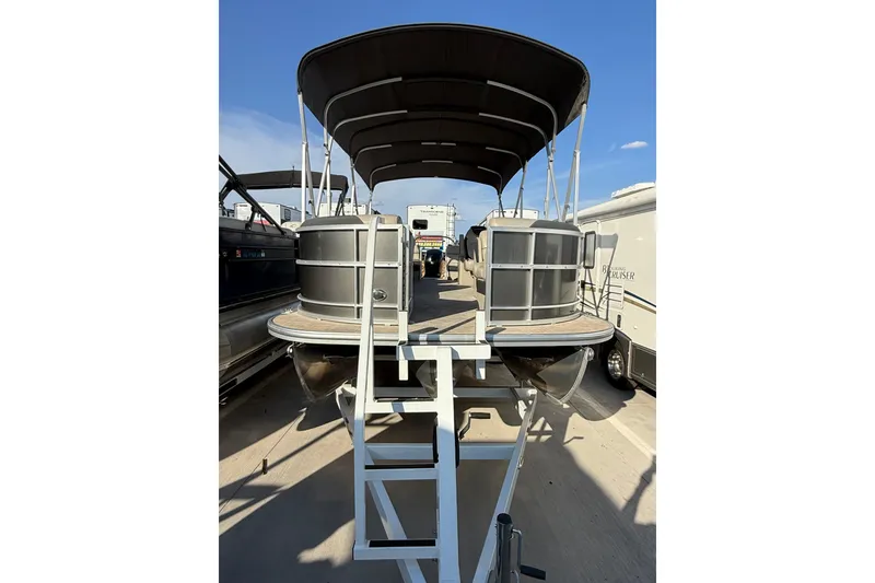 Slide: The Image of 2023 South Bay 224RS LE pontoon boat with canopy, displayed on a trailer. - 5