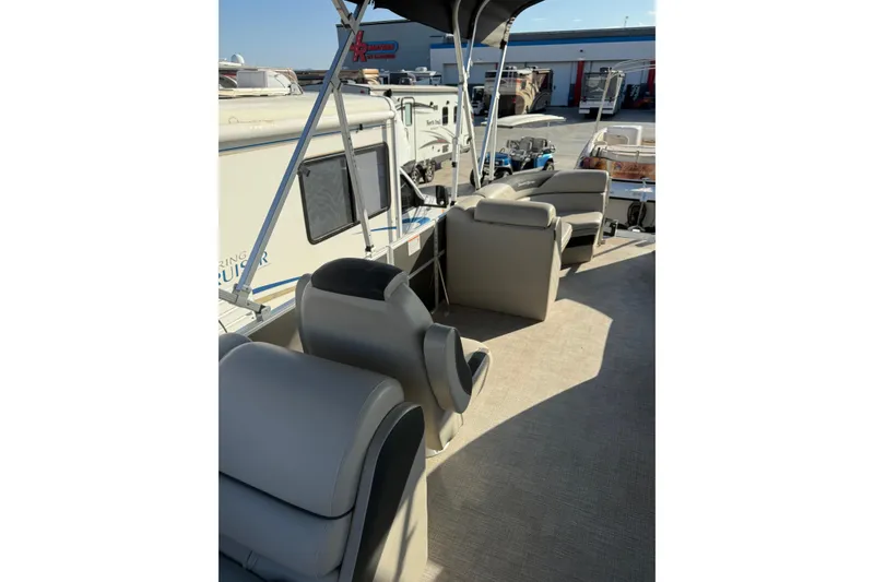 Slide: The Image of 2023 South Bay 224RS LE pontoon boat interior with comfortable seating and canopy. - 13