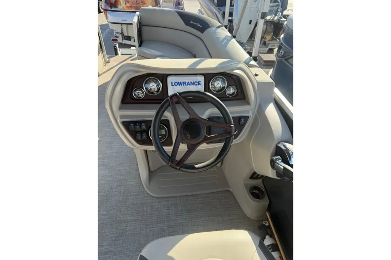 Slide: The Image of 2023 South Bay 224RS LE boat dashboard with steering wheel and Lowrance display. - 12