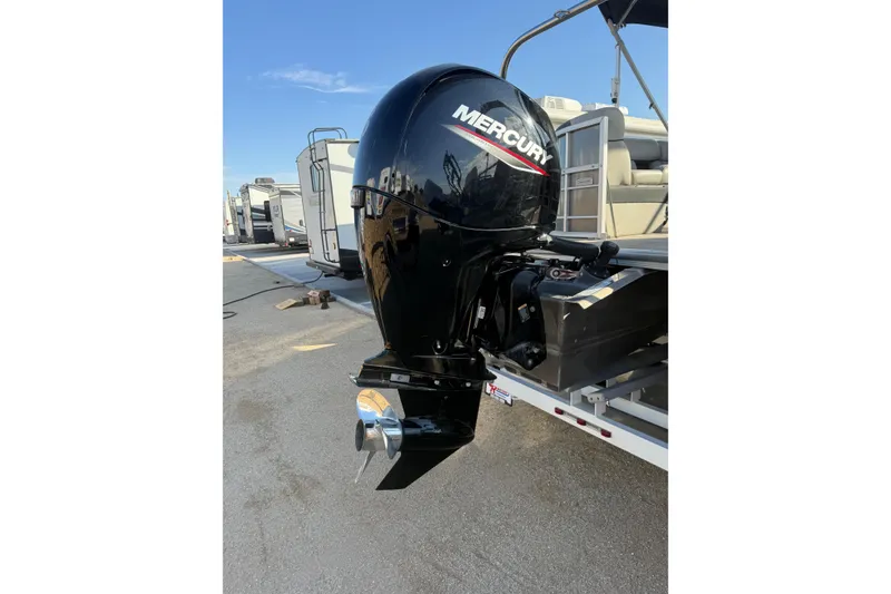 Slide: The Image of 2023 South Bay 224RS LE boat with Mercury outboard motor in a marina setting. - 17