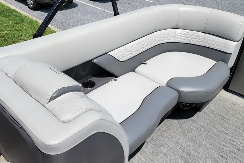 Slide: The Image of Luxurious seating on 2021 Godfrey Monaco 235 C pontoon boat, featuring elegant gray upholstery. - 13