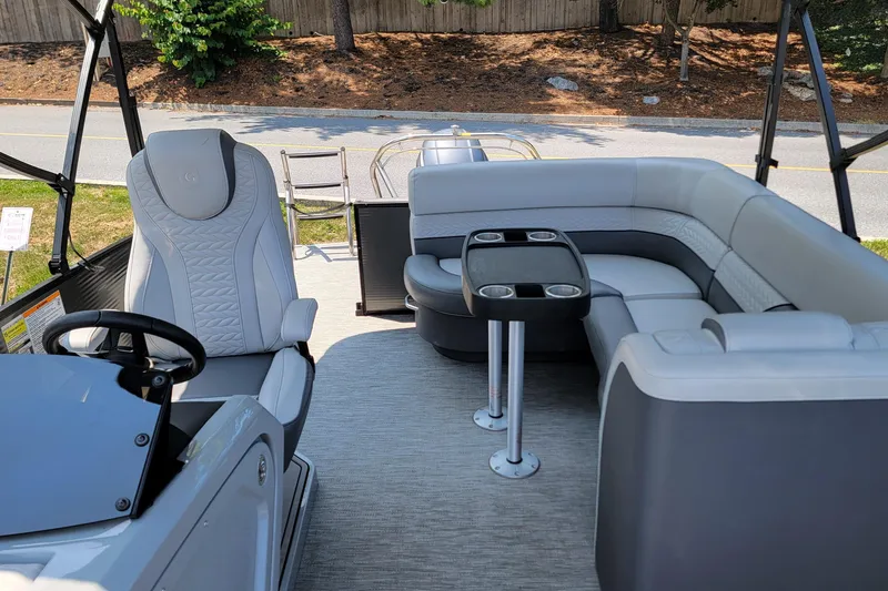 Slide: The Image of Interior of 2021 Godfrey Monaco 235 C pontoon boat with plush seating and steering console. - 7