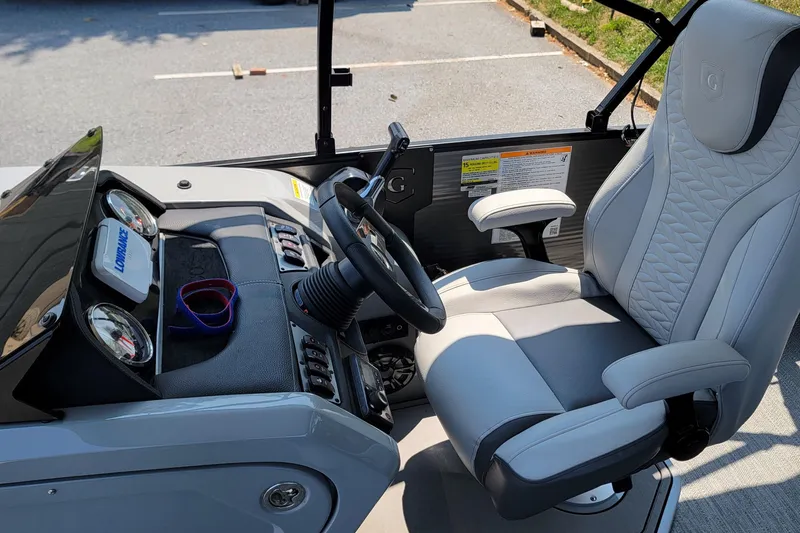 Slide: The Image of Interior of 2021 Godfrey Monaco 235 C boat with steering wheel and captain's chair. - 11