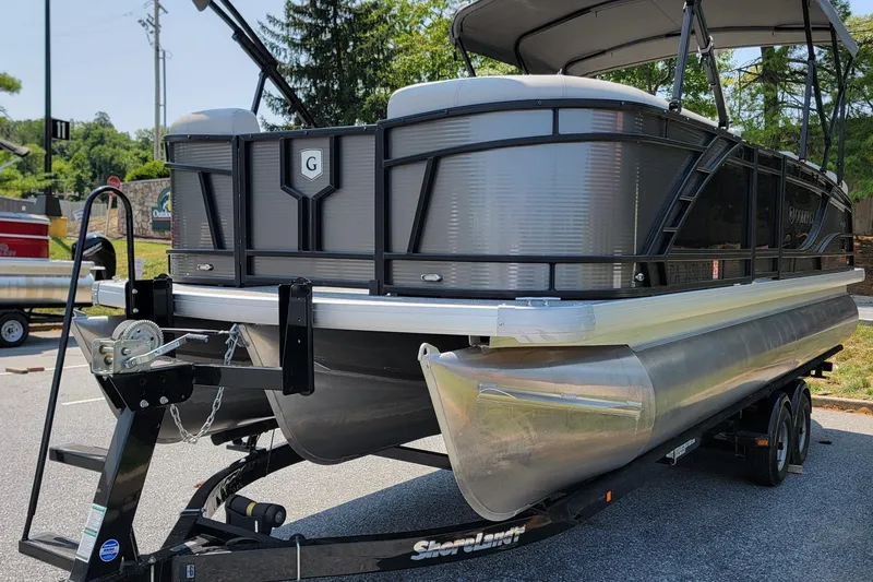 Slide: The Image of 2021 Godfrey Monaco 235 C pontoon boat on trailer, parked outdoors. - 6