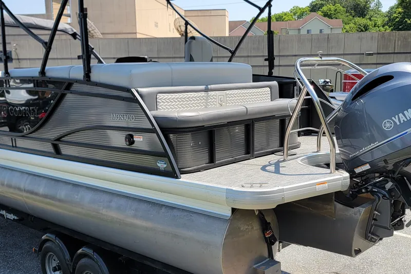 Slide: The Image of 2021 Godfrey Monaco 235 C pontoon boat with Yamaha outboard motor, parked on a trailer. - 4