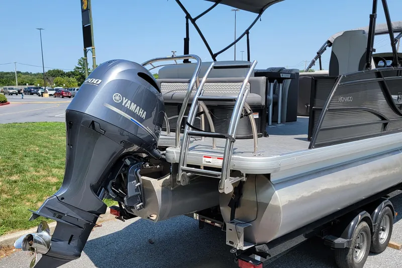 Slide: The Image of 2021 Godfrey Monaco 235 C pontoon boat with Yamaha 200 engine, parked outdoors. - 3