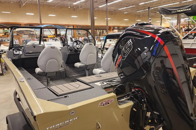 Slide: The Image of 2027 Tracker Pro Guide V-175 Combo boat with powerful engine, showcased indoors. - 5