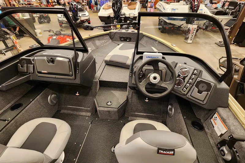 Slide: The Image of Interior view of 2027 Tracker Pro Guide V-175 Combo boat, featuring steering console and seating. - 2