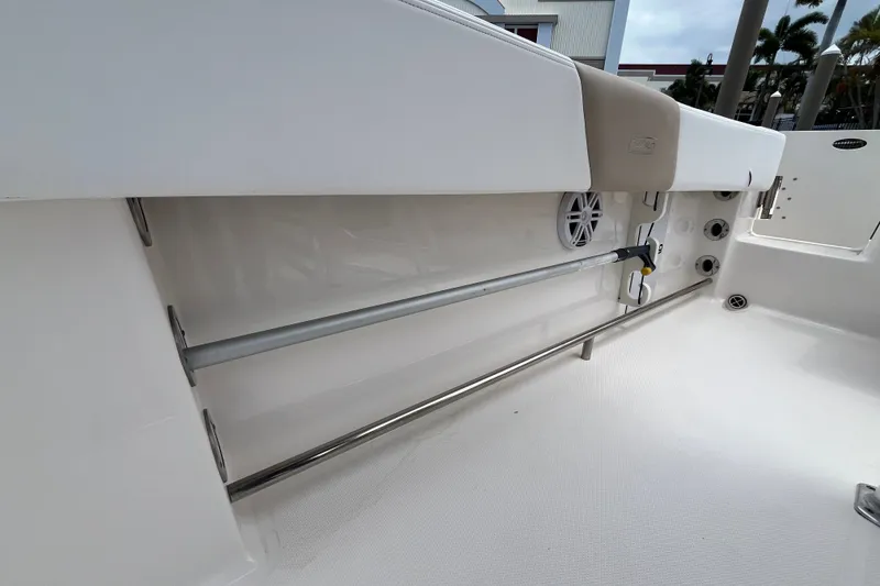Slide: The Image of 2019 Robalo R242 Center Console boat interior with rod holders and speaker. - 17
