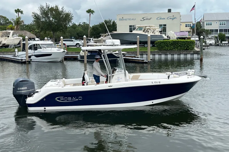 The Image of 2019 Robalo R242 Center Console boat with Yamaha engine in marina setting. - 2