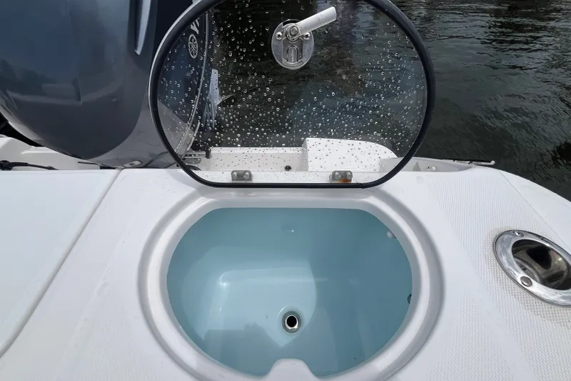 Slide: The Image of Livewell on 2019 Robalo R242 Center Console boat, open lid, water droplets visible. - 27