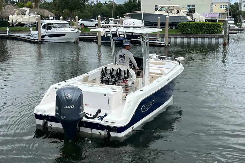 Slide: The Image of 2019 Robalo R242 Center Console boat on water, featuring Yamaha 300 engine. - 4