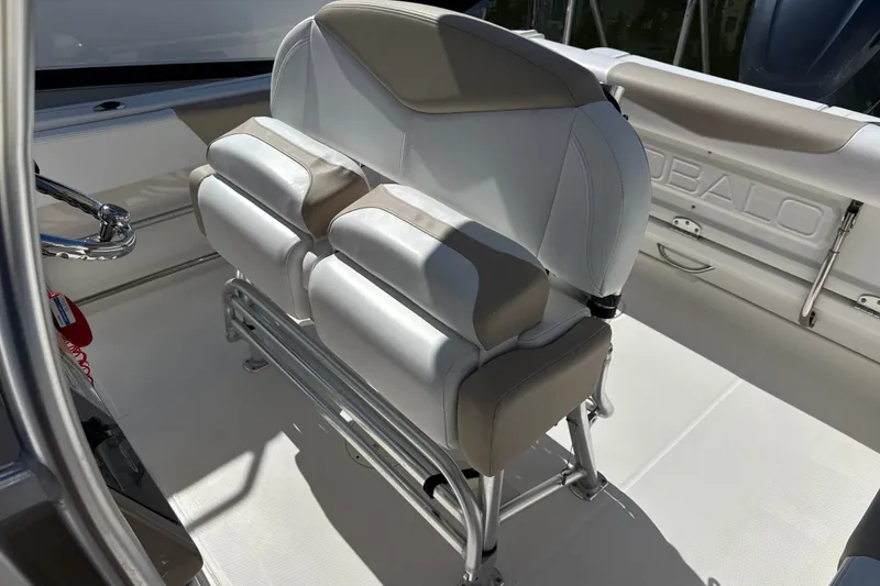 Slide: The Image of 2019 Robalo R242 Center Console boat interior with cushioned seating and stainless steel fixtures. - 16