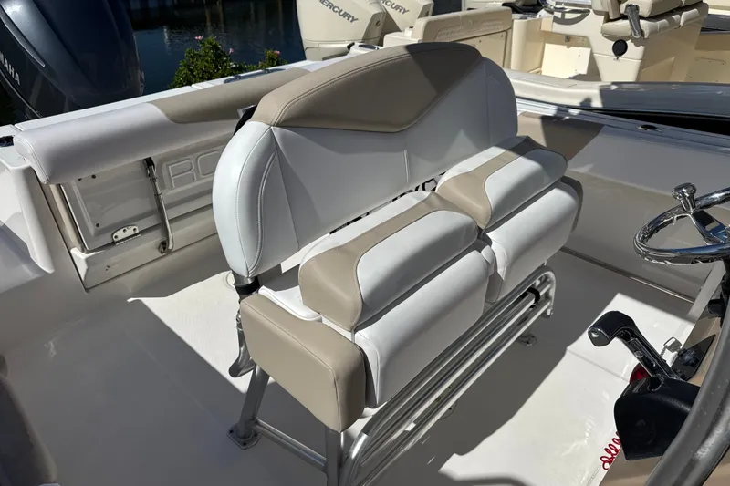 Slide: The Image of 2019 Robalo R242 Center Console boat interior with cushioned seating and steering wheel. - 15