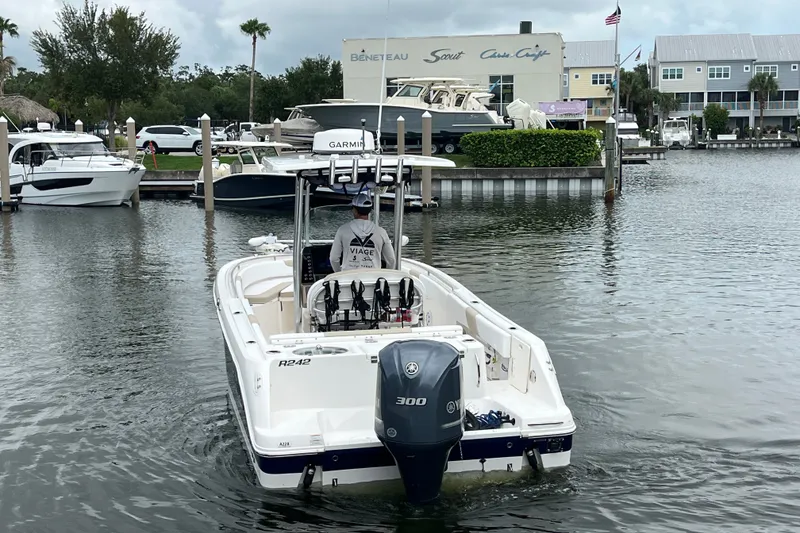 Slide: The Image of 2019 Robalo R242 Center Console boat navigating marina waters. - 5