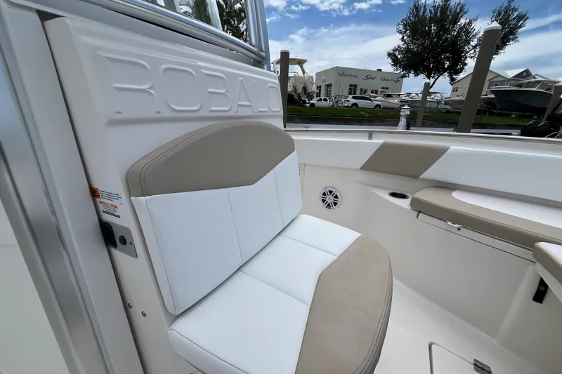 Slide: The Image of 2019 Robalo R242 Center Console boat interior with cushioned seating and sleek design. - 25