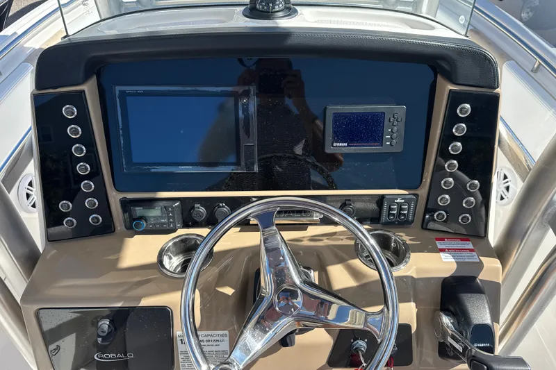 Slide: The Image of 2019 Robalo R242 Center Console dashboard with steering wheel and electronic displays. - 18