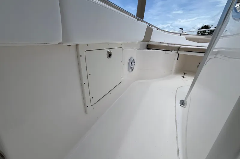 Slide: The Image of 2019 Robalo R242 Center Console boat interior with storage compartment and seating. - 15