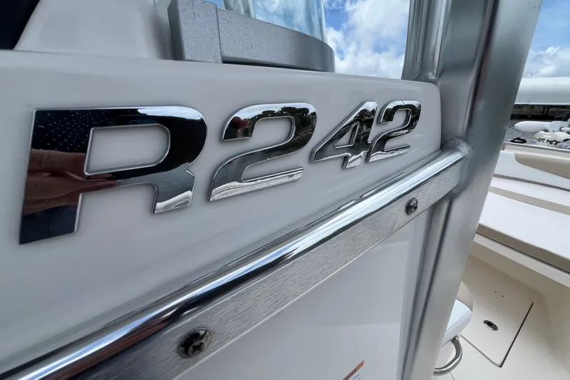 Slide: The Image of 2019 Robalo R242 Center Console boat, close-up of chrome model emblem. - 10