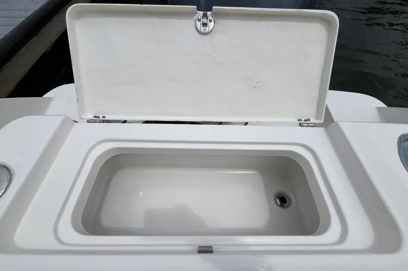 Slide: The Image of Open storage compartment on 2019 Robalo R242 Center Console boat. - 28