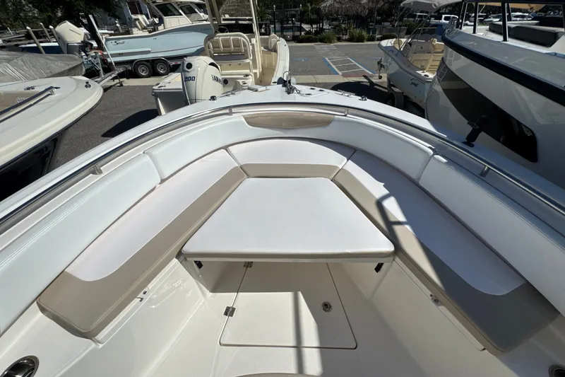 Slide: The Image of 2019 Robalo R242 Center Console boat with spacious seating and table in the bow area. - 28