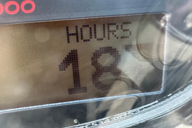 Slide: The Image of Hour meter displaying 18 hours on a 2018 Crownline Eclipse E30 boat. - 24