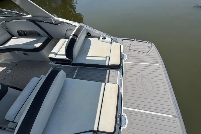 Slide: The Image of 2018 Crownline Eclipse E30 boat interior with cushioned seating and swim platform. - 2
