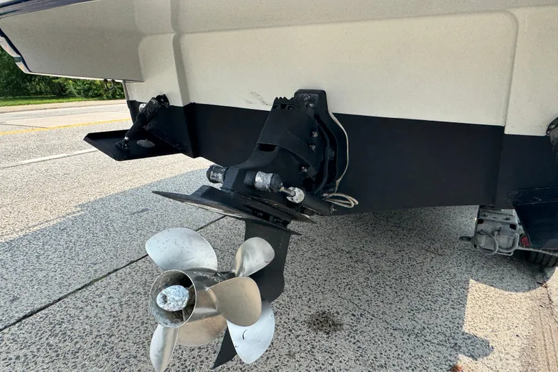 Slide: The Image of 2018 Crownline Eclipse E30 boat propeller and stern on a trailer. - 2