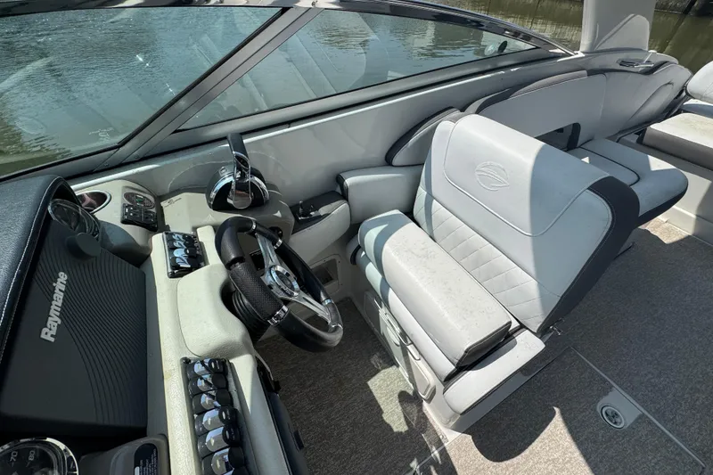 Slide: The Image of 2018 Crownline Eclipse E30 boat interior with steering wheel and control panel. - 14
