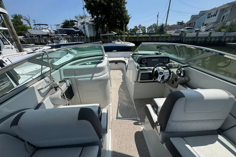 Slide: The Image of 2018 Crownline Eclipse E30 boat interior with modern dashboard and seating. - 9