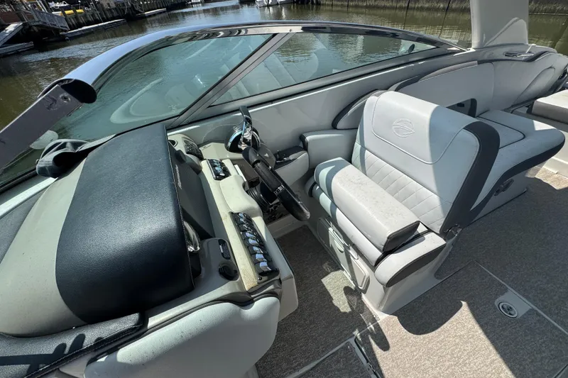 Slide: The Image of Interior view of a 2018 Crownline Eclipse E30 boat, featuring sleek seating and control panel. - 11
