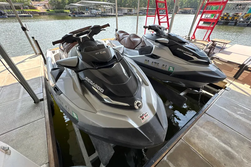 Slide: The Image of 2018 Sea-Doo GTX Limited 300 jet skis docked by a scenic lakeside. - 5
