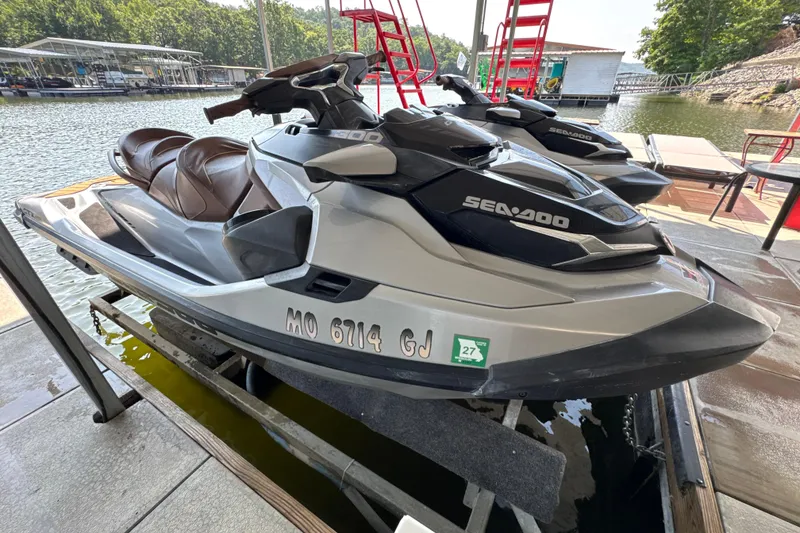 Slide: The Image of 2018 Sea-Doo GTX Limited 300 jet ski docked by the water. - 1