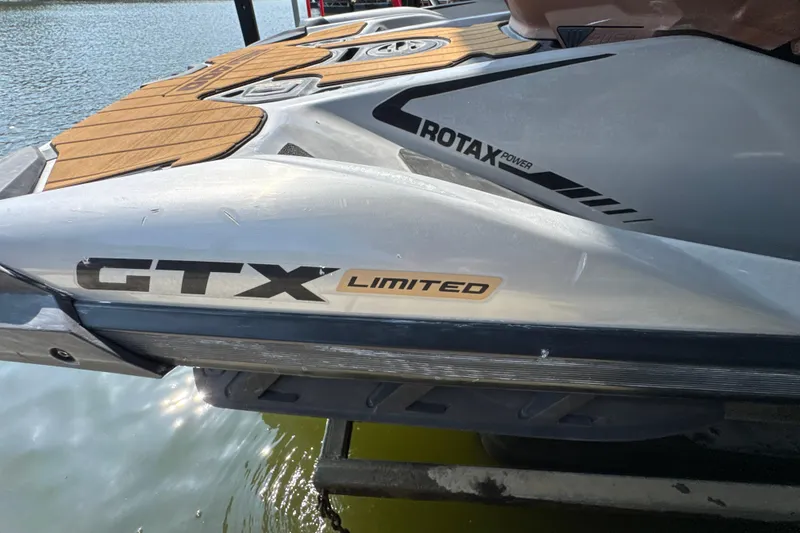Slide: The Image of 2018 Sea-Doo GTX Limited 300 jet ski with Rotax power, docked by the water. - 3