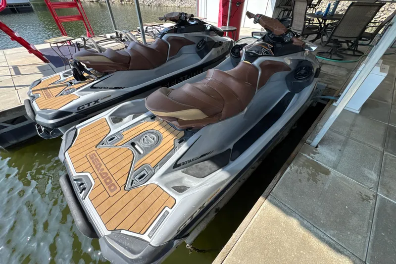 Slide: The Image of 2018 Sea-Doo GTX Limited 300 jet skis docked by the water. - 6