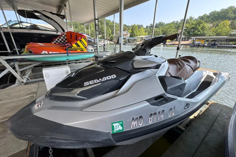 Slide: The Image of 2018 Sea-Doo GTX Limited 300 jet ski docked by a lakeside marina. - 2