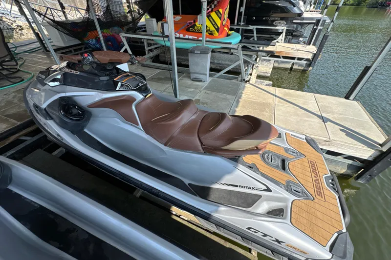 Slide: The Image of 2018 Sea-Doo GTX Limited 300 jet ski docked by the water. - 4