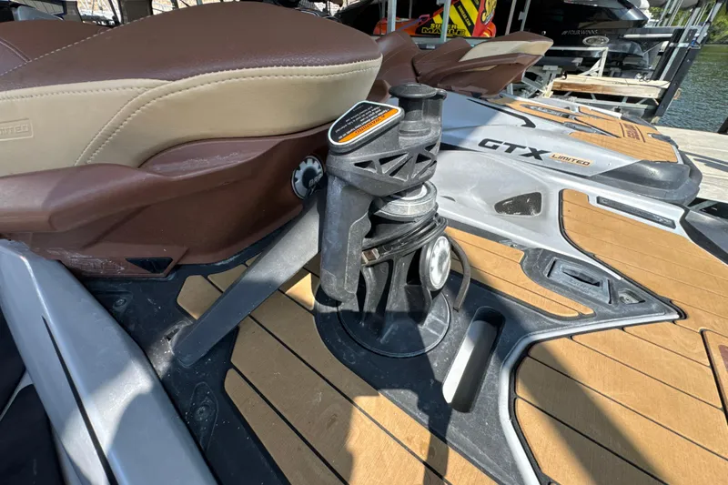 Slide: The Image of 2018 Sea-Doo GTX Limited 230 with brown seating and deck, docked near water. - 6