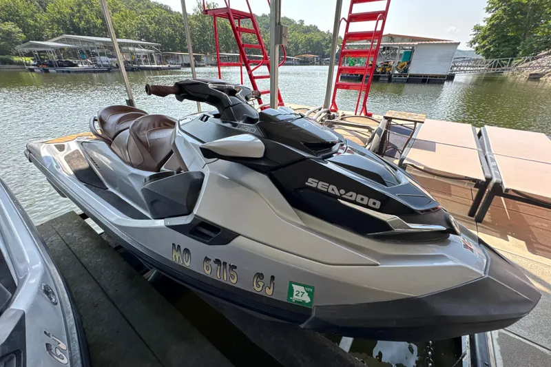 Slide: The Image of 2018 Sea-Doo GTX Limited 230 jet ski docked by a scenic lakeside. - 1