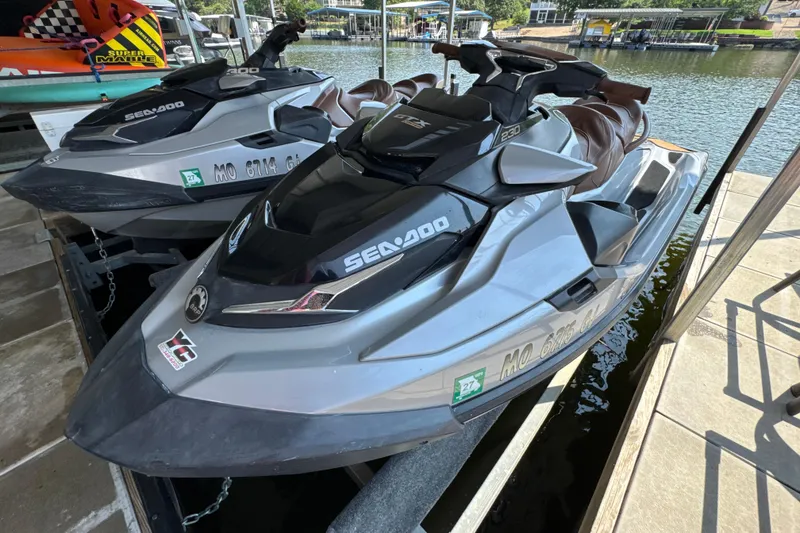 Slide: The Image of 2018 Sea-Doo GTX Limited 230 jet ski docked by the water. - 2
