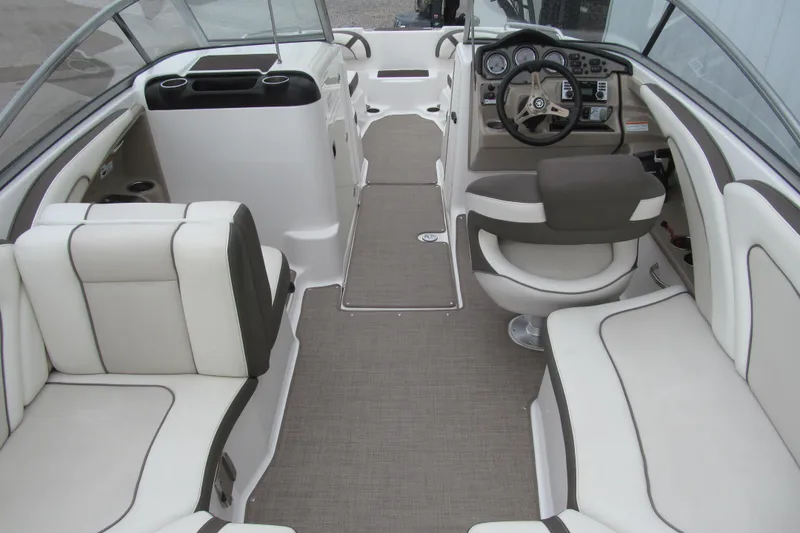 Slide: The Image of 2013 Yamaha Boats 242 Limited S interior with plush seating and modern dashboard. - 4