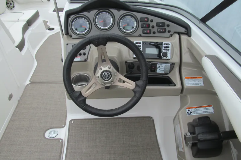 Slide: The Image of 2013 Yamaha Boats 242 Limited S dashboard with steering wheel and control panel. - 6