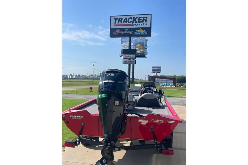 Slide: The Image of 2015 Tracker Pro Team 175 TXW boat with 75 HP engine, displayed outdoors. - 6
