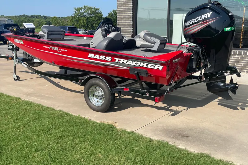 Slide: The Image of 2015 Tracker Pro Team 175 TXW bass boat with Mercury engine on trailer. - 2