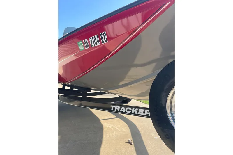 Slide: The Image of 2015 Tracker Pro Team 175 TXW boat on trailer, red and gray exterior, registration visible. - 5