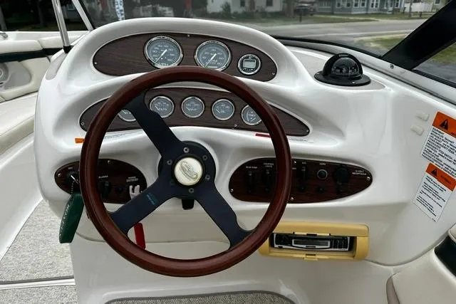 Slide: The Image of 1999 Chris-Craft 200 Bowrider SS dashboard with wood accents and steering wheel. - 12